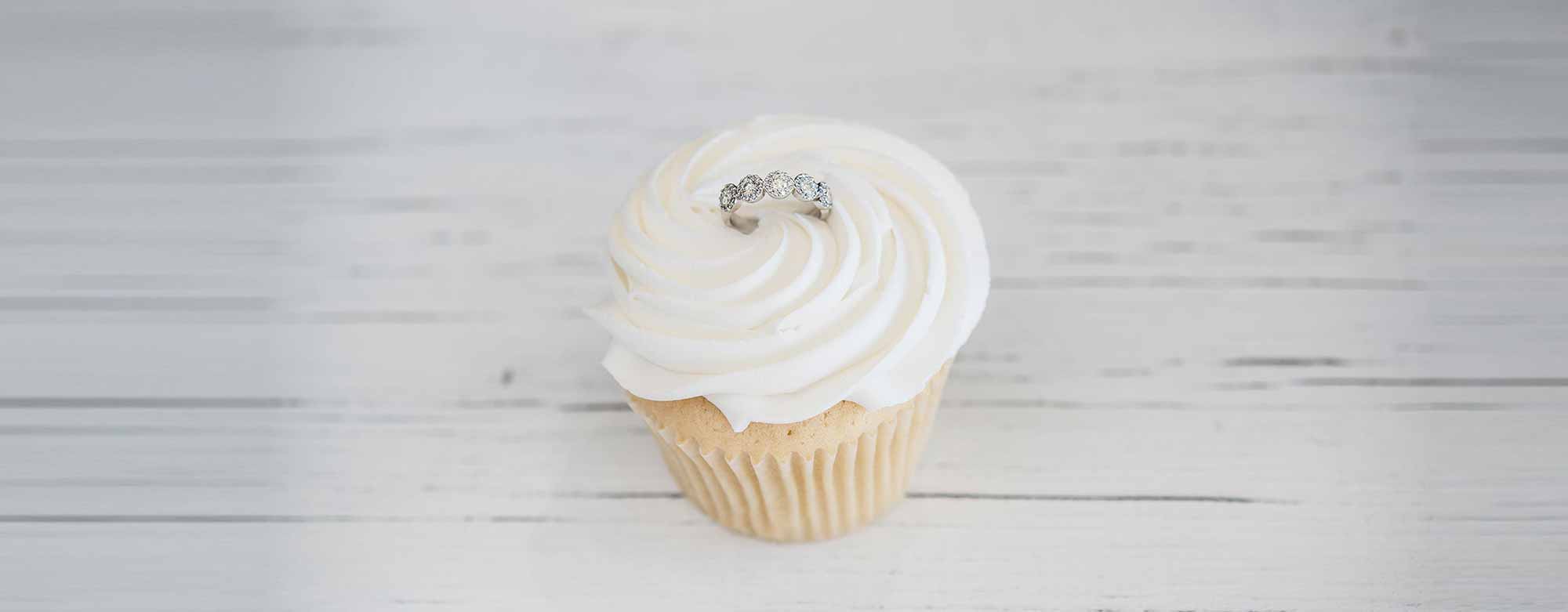 Vardy's Jewelers - Why we are different Background Image showing a cake with a diamond ring